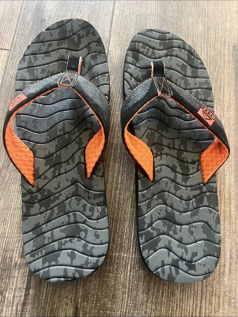Reef Roundhouse Flip Flops in orange and black